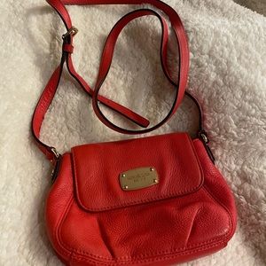 Small reddish orange Michael Kors crossbody